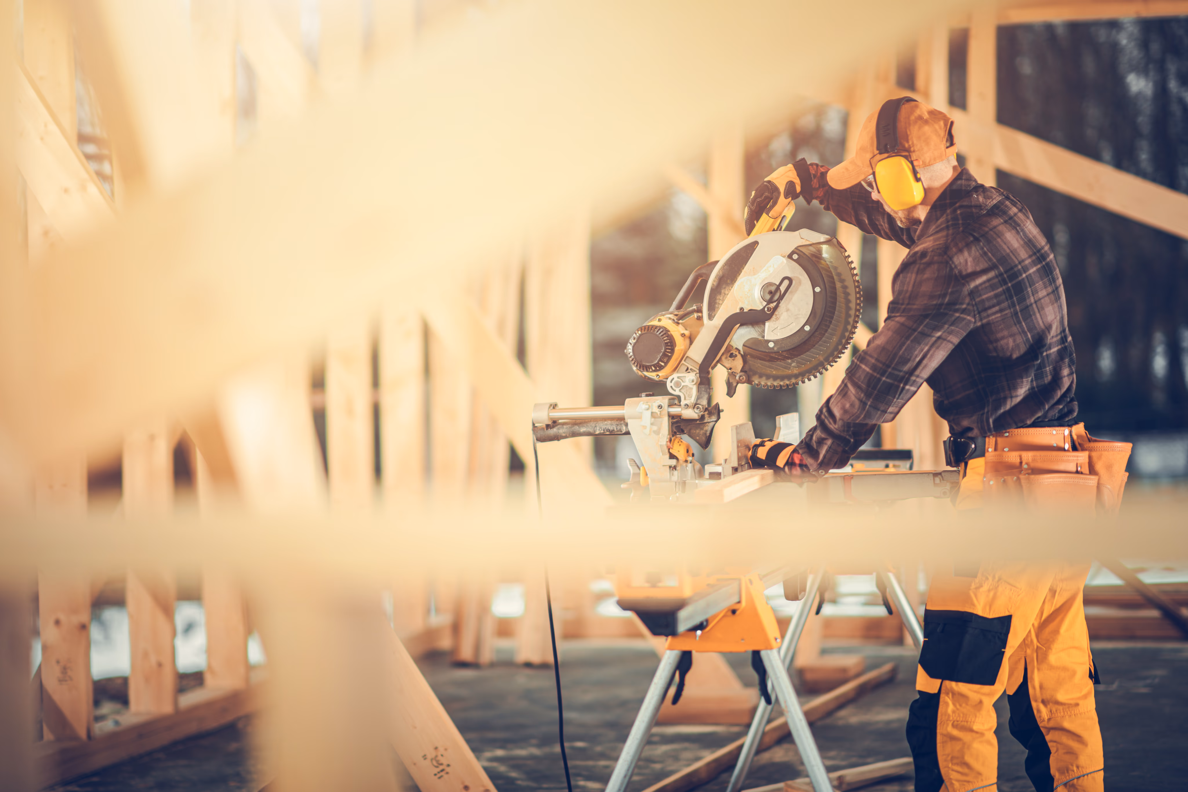 Lead builder and apprentice at golden hour construction site