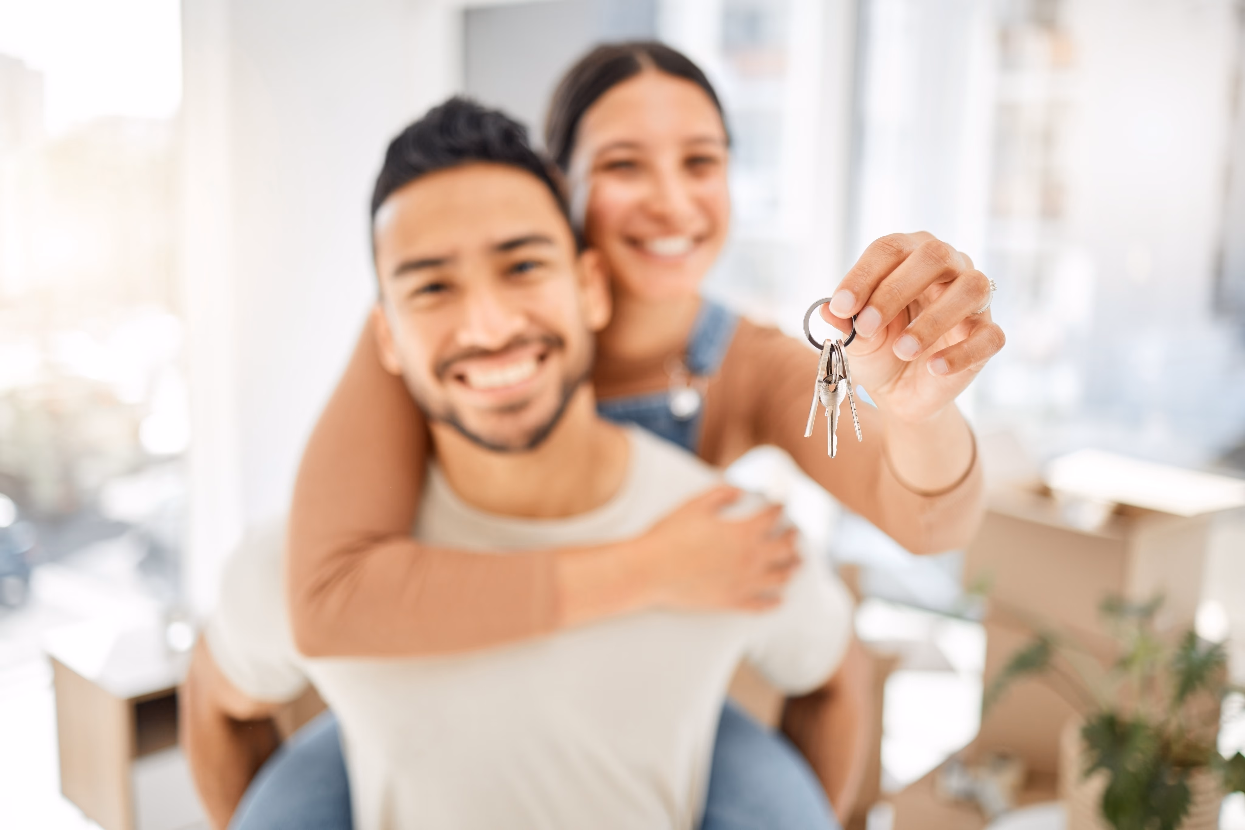Homeowners celebrating with keys — the Primetegrity standard